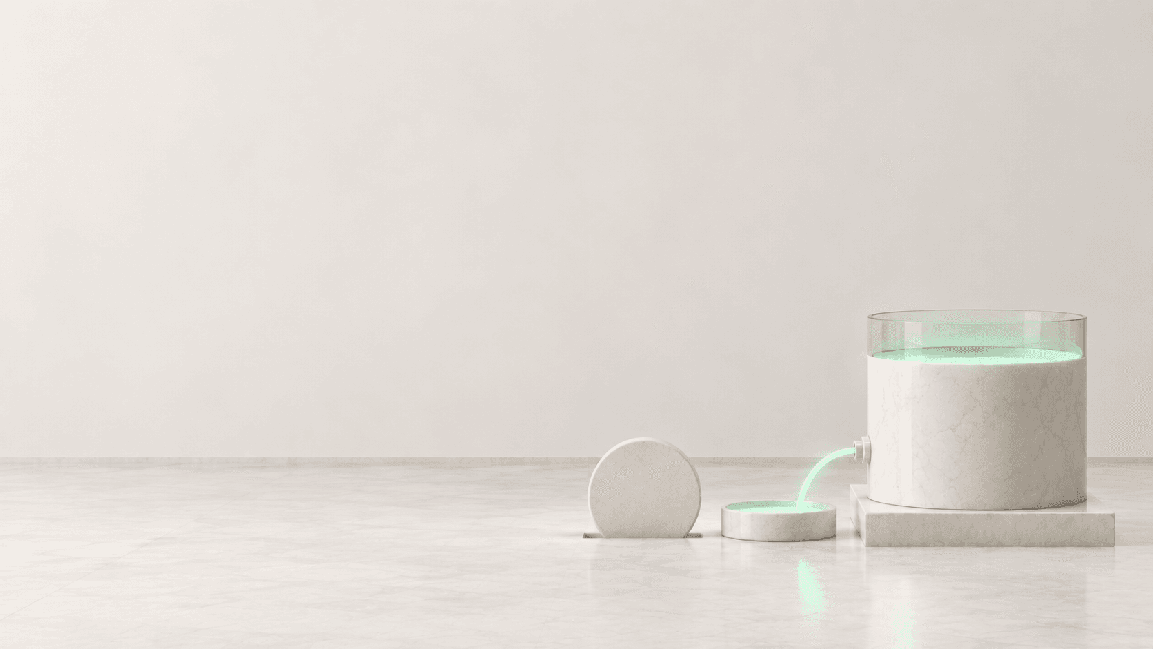 A marble reserve vessel releases a mint-green stream into a shallow dish while a blank disc enters a slot beside it.